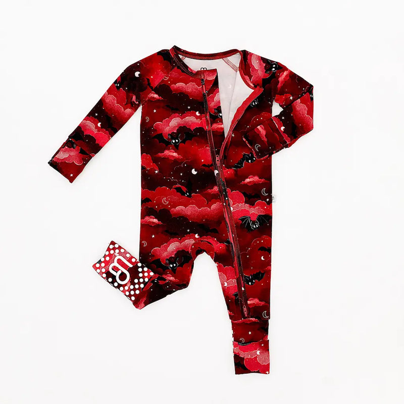 Red and black patterned baby onesie with a front zipper accompanied by a matching pouch, displayed on a white background