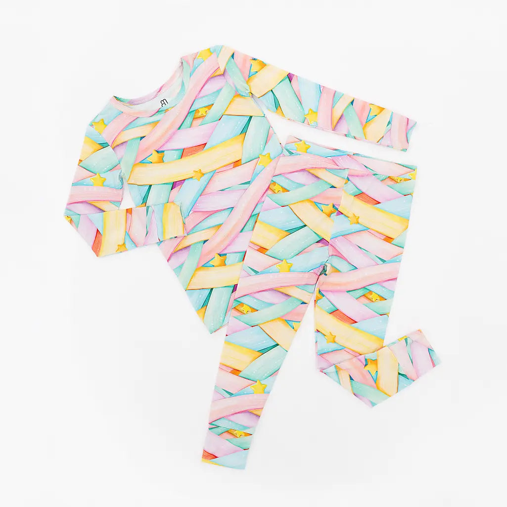 Colorful pastel abstract patterned long-sleeve shirt and pants set with stars on a white background