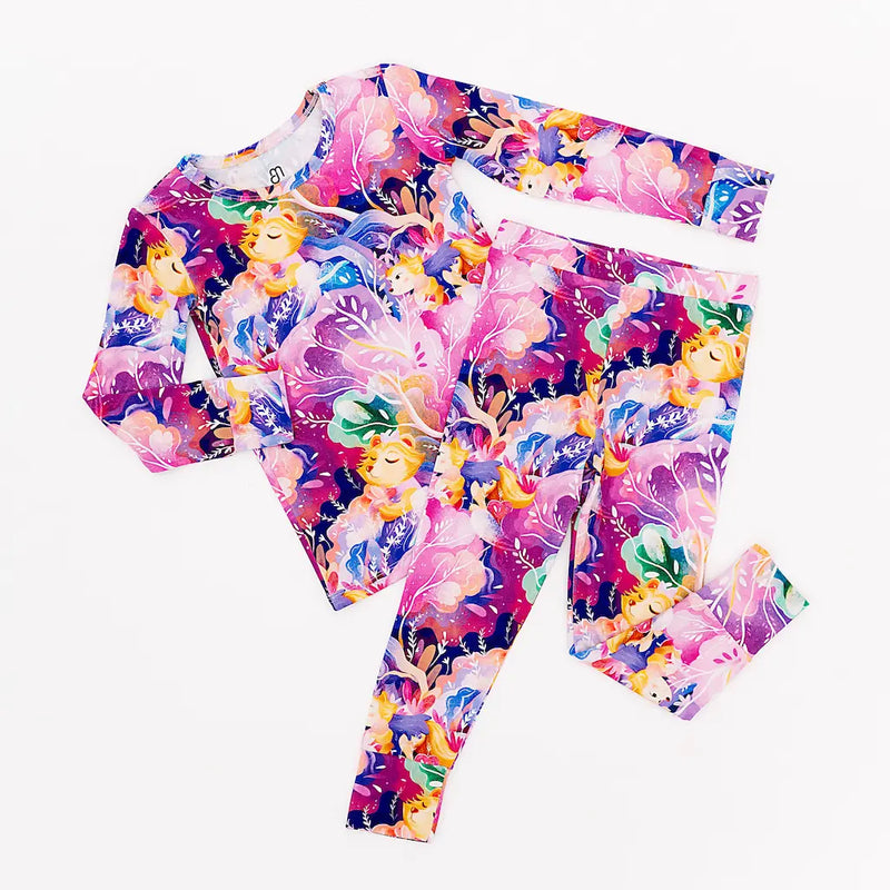 Colorful floral-patterned long-sleeve top and leggings set featuring whimsical fantasy motifs on a white background