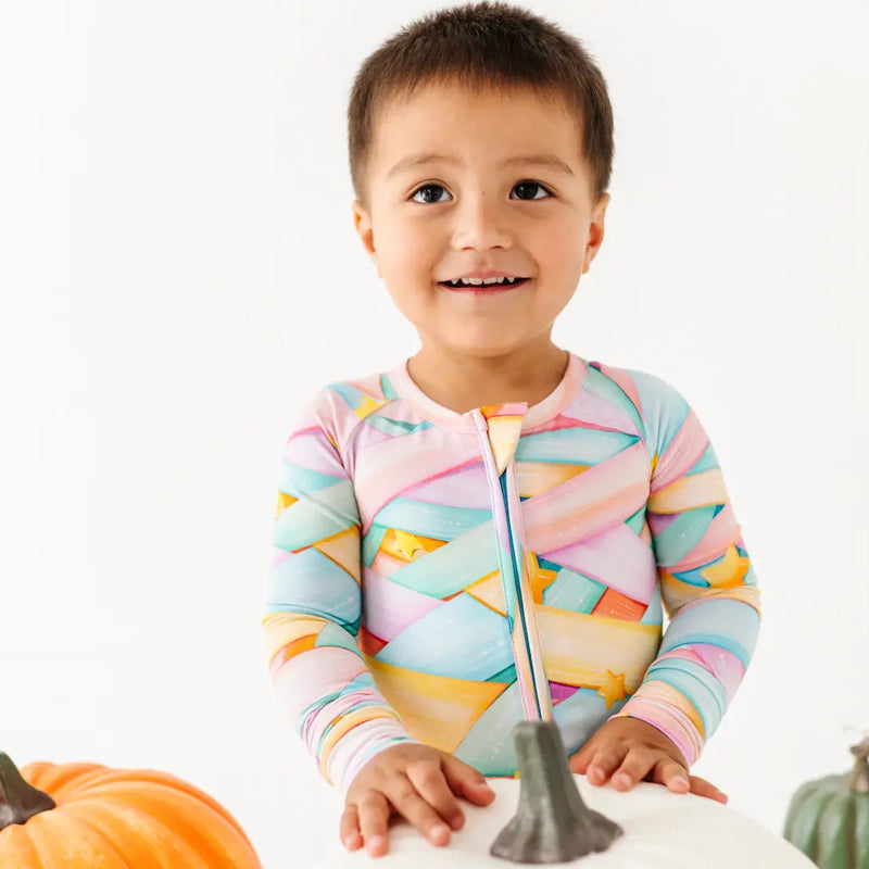 Person wearing orange pumpkin-patterned leggings on a light blue background