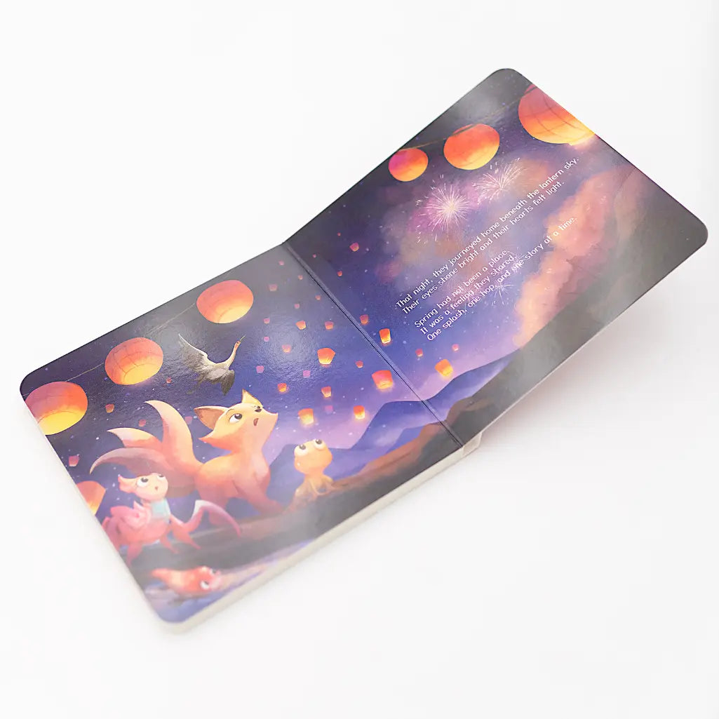 Illustrated book with foxes and celestial elements on a white background
