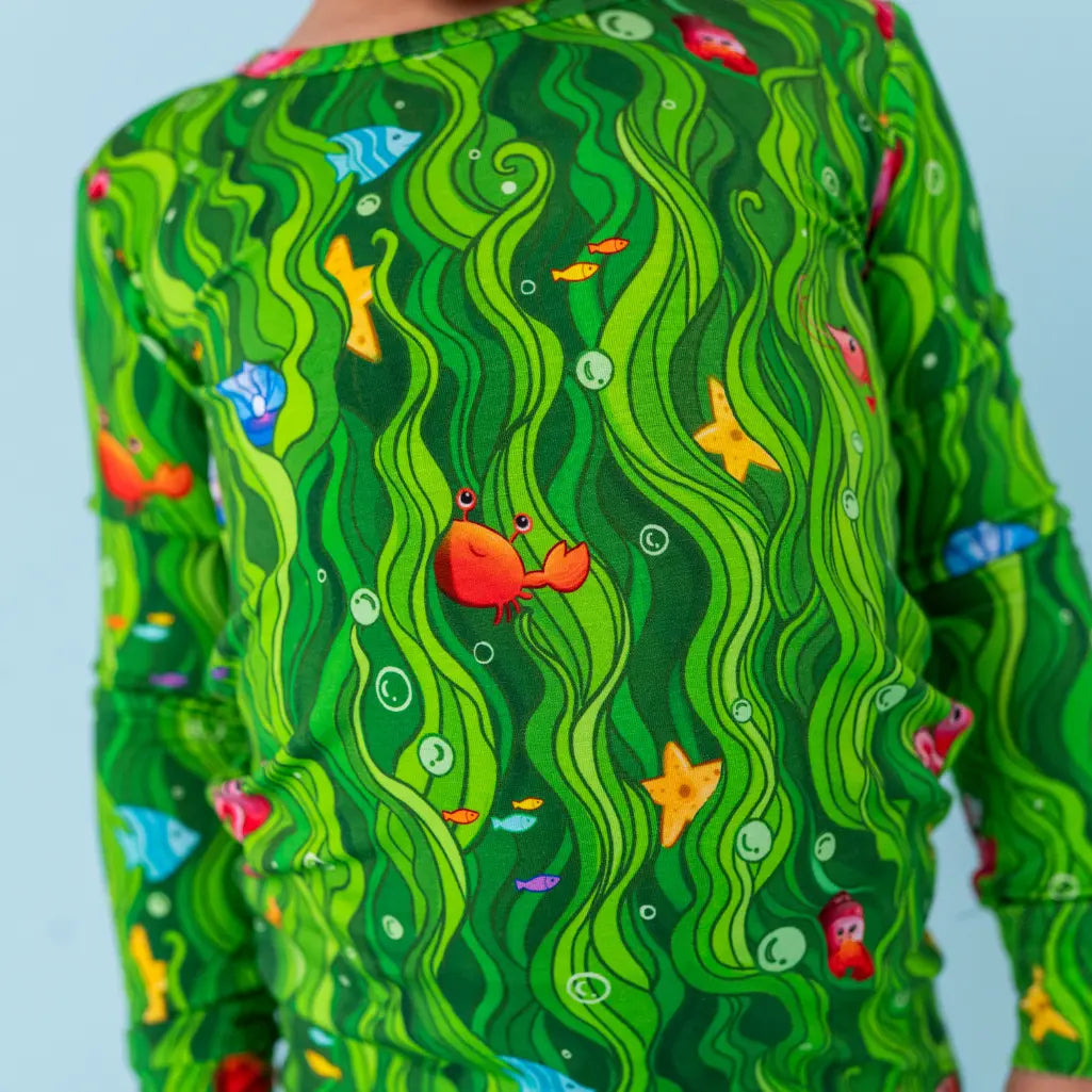 Green patterned shirt with underwater design featuring fish and a crab.