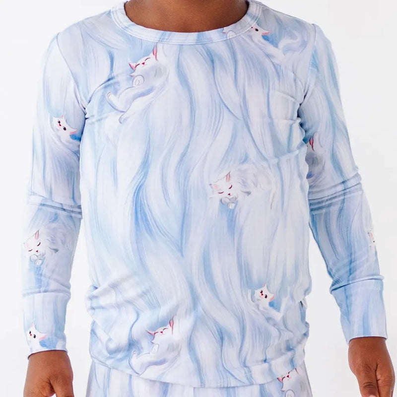 Long-sleeve shirt with a blue and white abstract pattern on a plain background