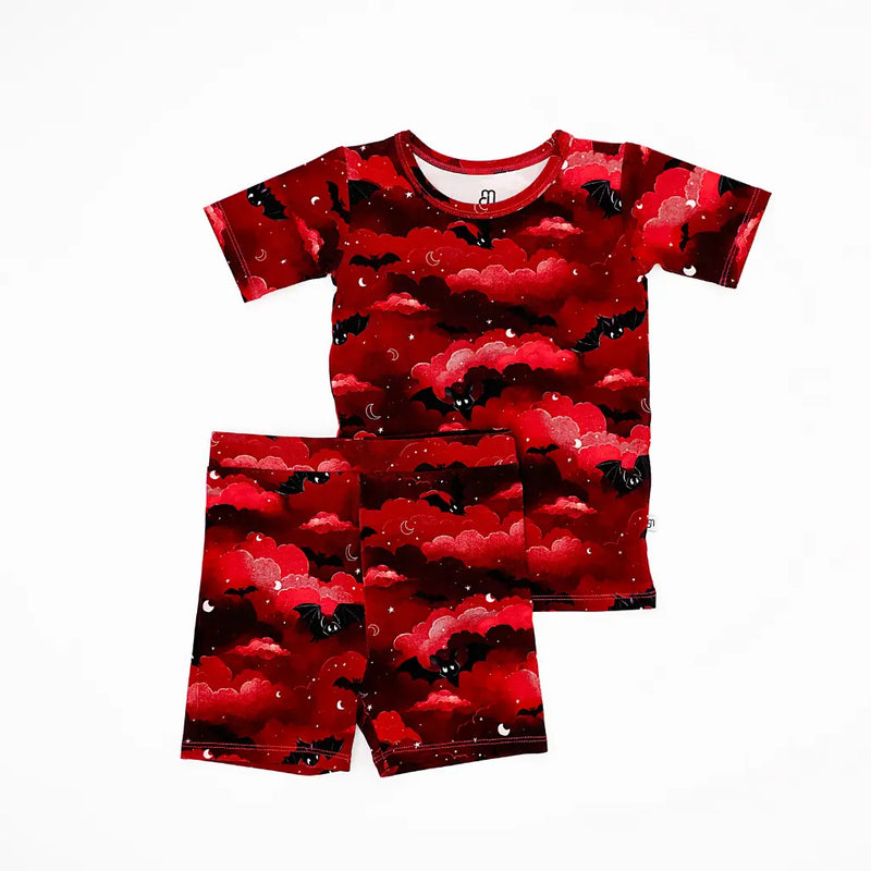 Red and black patterned pajama set on a white background