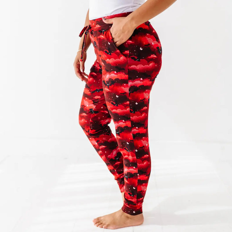 Red and black checkered leggings worn by a person on a white background