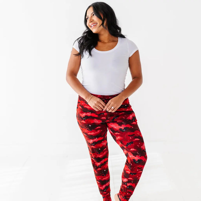Woman wearing red camouflage leggings and a white t-shirt on a white background