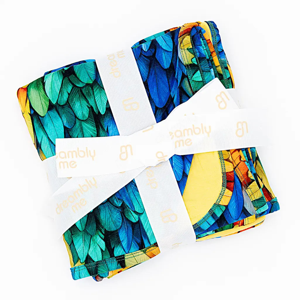 Colorful patterned fabric swatches with 'omblu me' branding on a white background