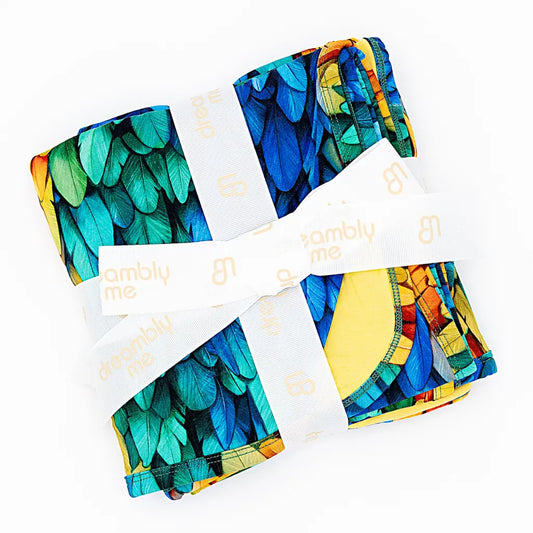 Colorful patterned fabric swatches with 'omblu me' branding on a white background