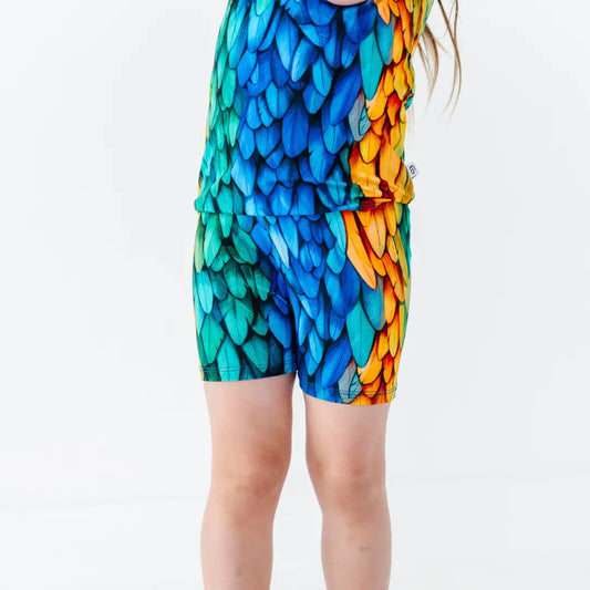 Colorful dragon scale patterned shorts on a plain background