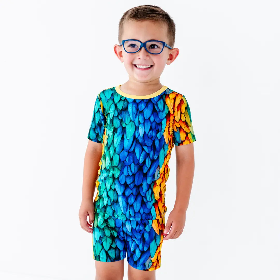 Child wearing a colorful patterned outfit on a white background