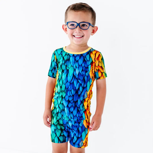 Child wearing a colorful patterned outfit on a white background