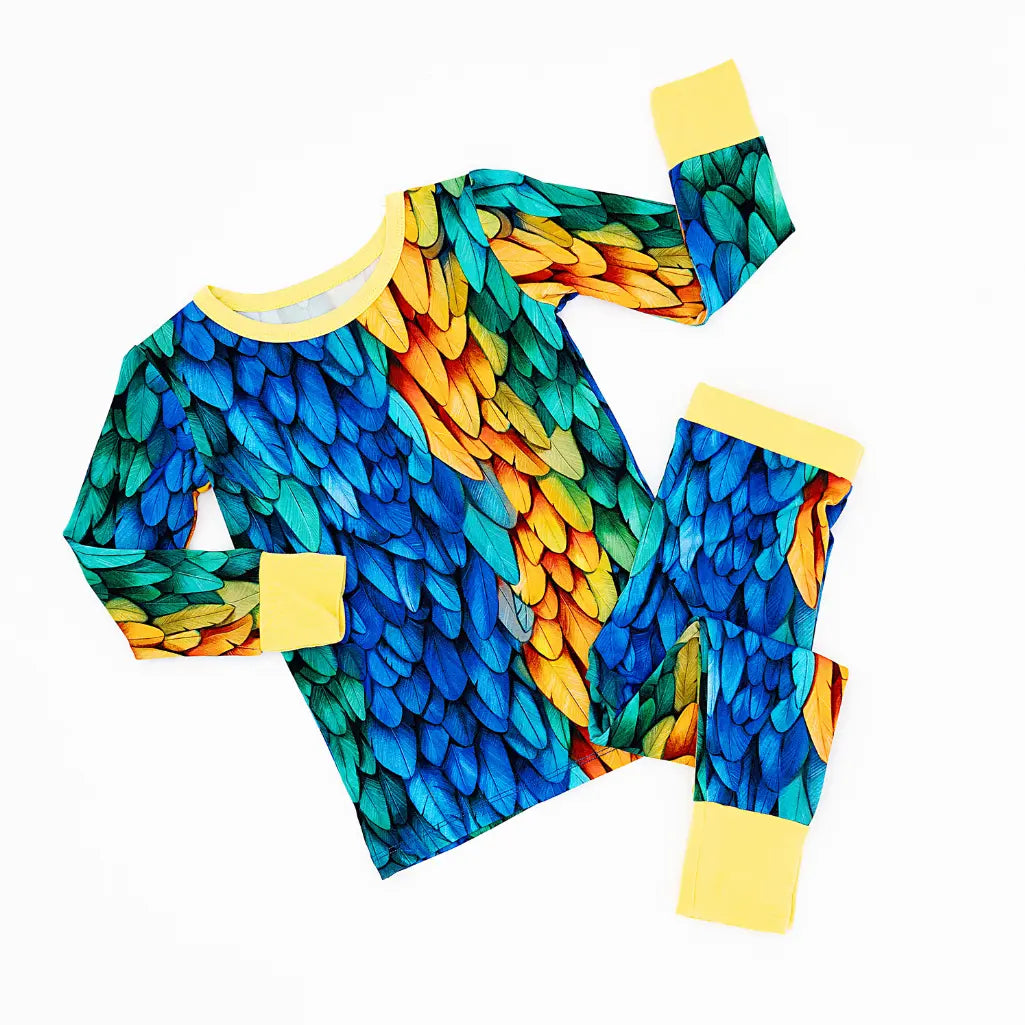 Colorful feather-patterned outfit with yellow accents on a white background