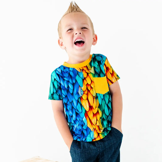 Child wearing a colorful shirt with a white background