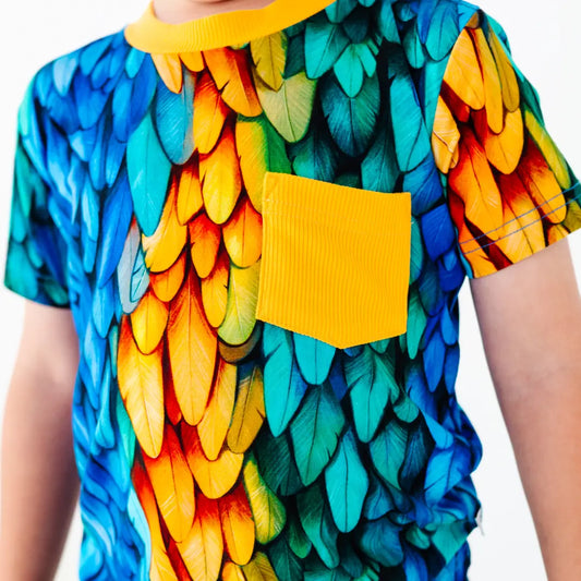 Colorful shirt with a leaf pattern and yellow pocket on a white background