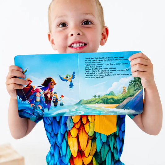 Child holding a colorful book open to a page with a tropical scene
