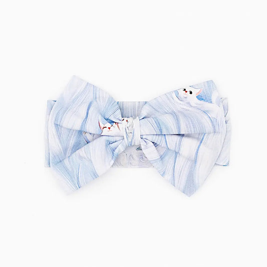 Blue and white marbled bow tie with cat design on a white background
