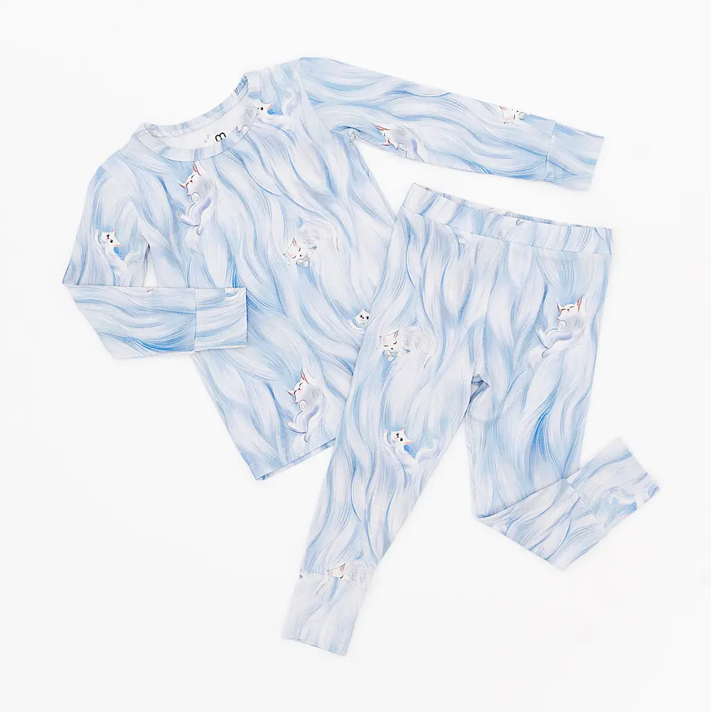 Children's pajama set with blue and white pattern on a white background