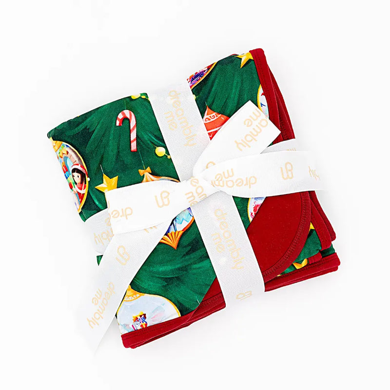 Set of folded Christmas-themed towels with decorative elements on a white background