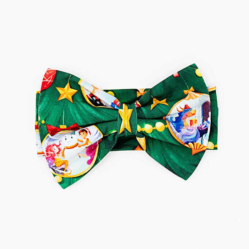 Green bow tie with colorful circus-themed design on a white background