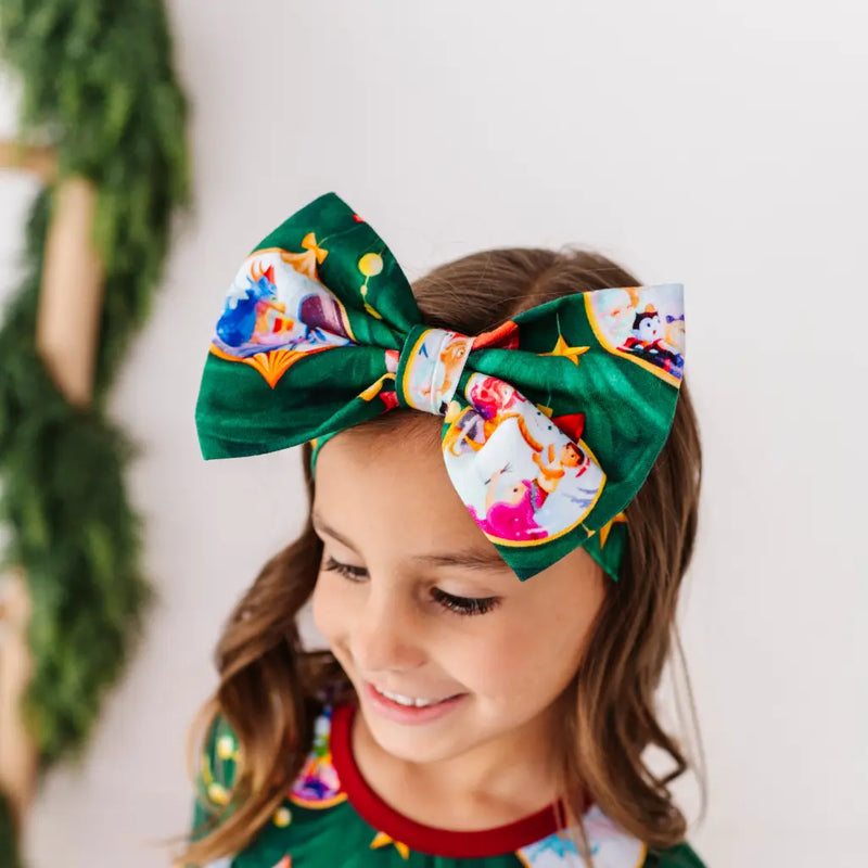 Child wearing a colorful headband with cartoon characters against a neutral background