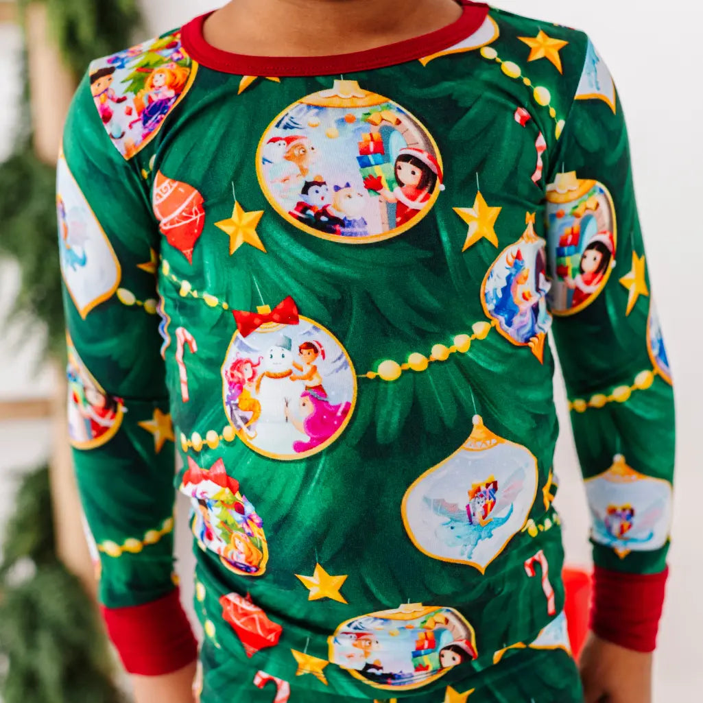 Green Christmas-themed pajama set with colorful designs on a blurred background
