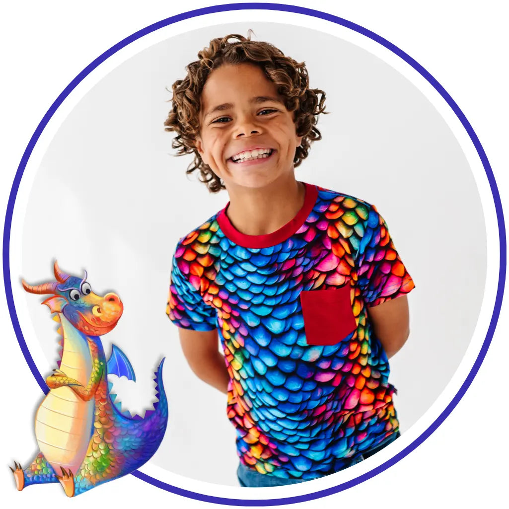 Child wearing a colorful dragon-themed shirt with a cartoon dragon on a white background