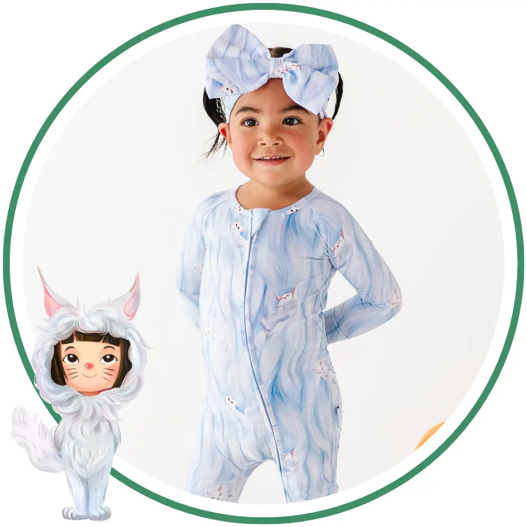Child wearing a blue and white onesie with a matching headband, surrounded by a circular border