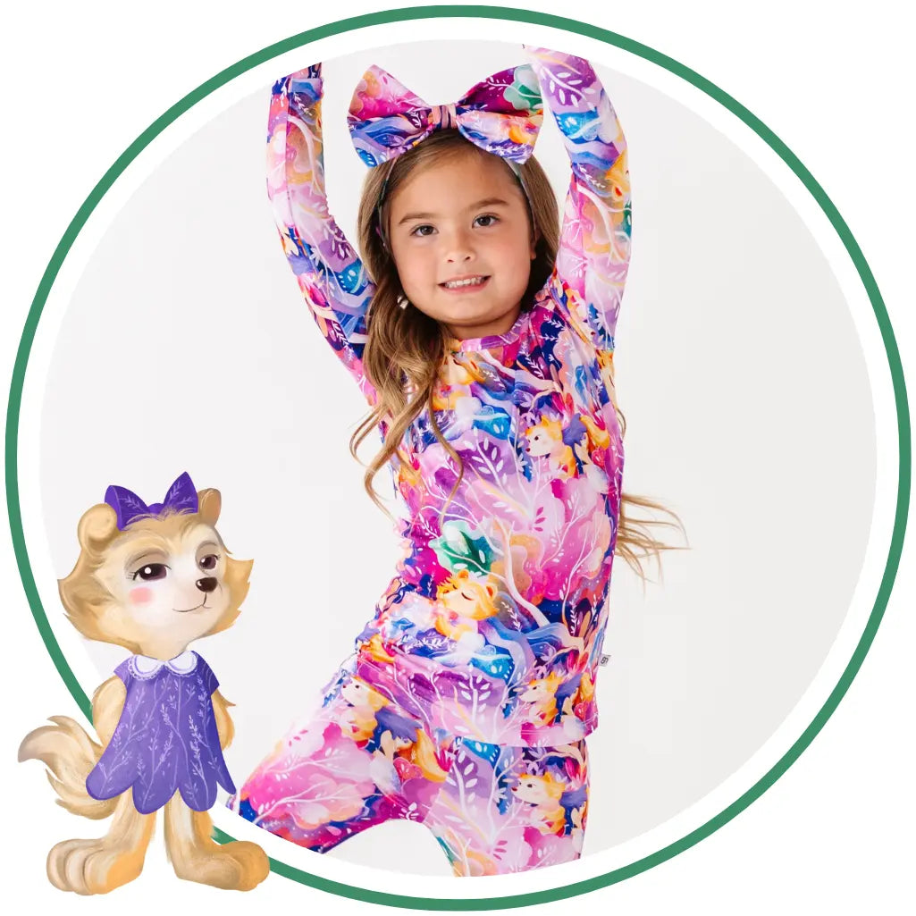 Child wearing a colorful outfit with a cartoon character next to them