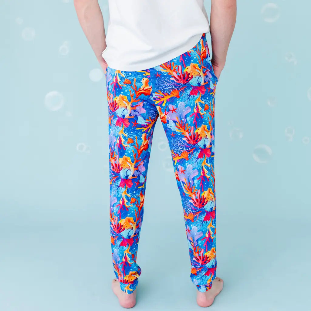 Colorful abstract-patterned leggings worn by a person on a light blue background.