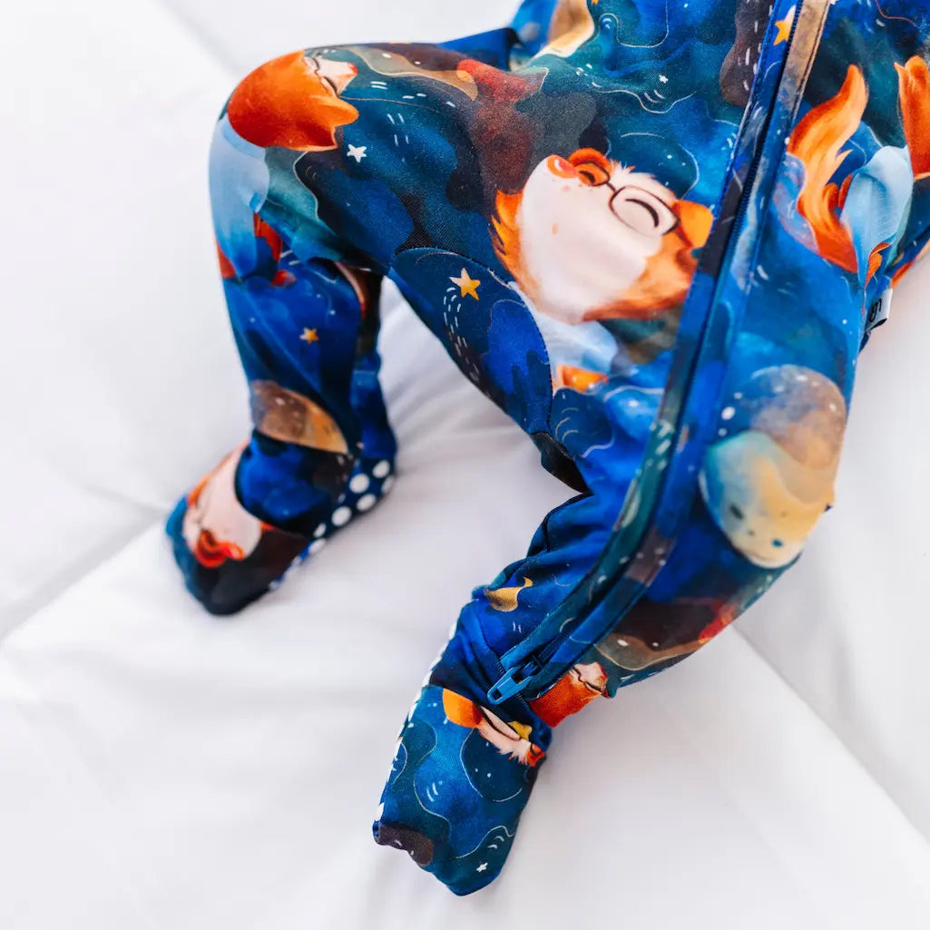 Colorful space-themed leggings with a child-like design on a white surface