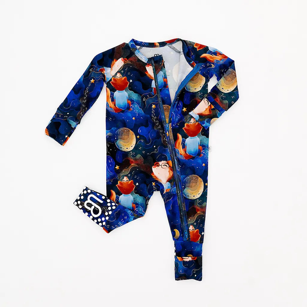 Children's onesie with space-themed design on a white background