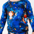 Children's shirt with space-themed design featuring stars, planets, and a rocket.