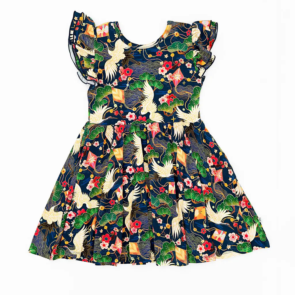 Colorful dress with bird and floral pattern on a white background