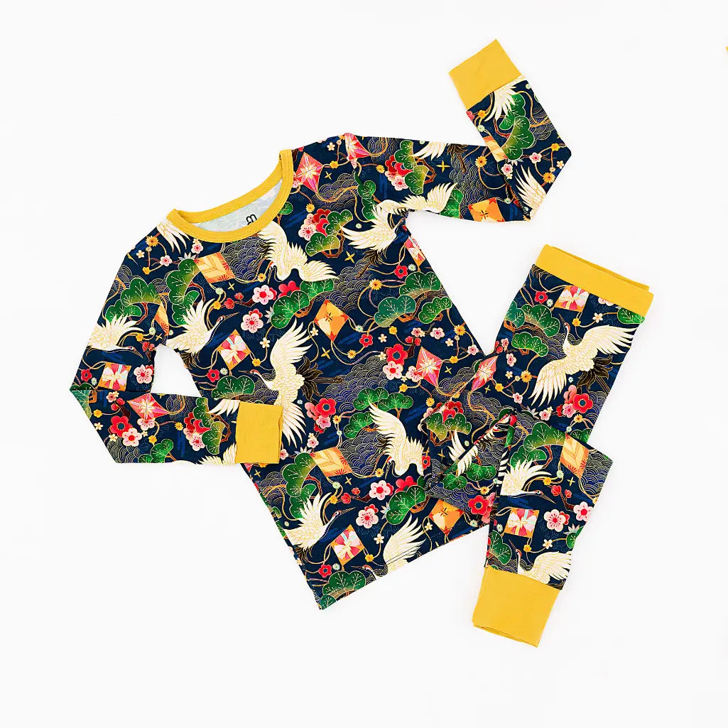 Children's pajama set with crane and floral pattern on a white background