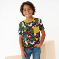 Child wearing a colorful patterned shirt with a yellow pocket on a white background