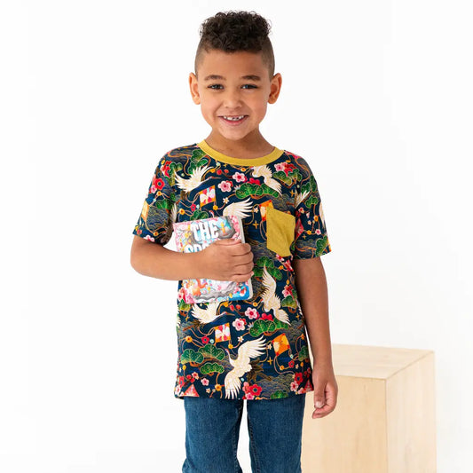 Child wearing a colorful t-shirt with nature-themed design on a white background