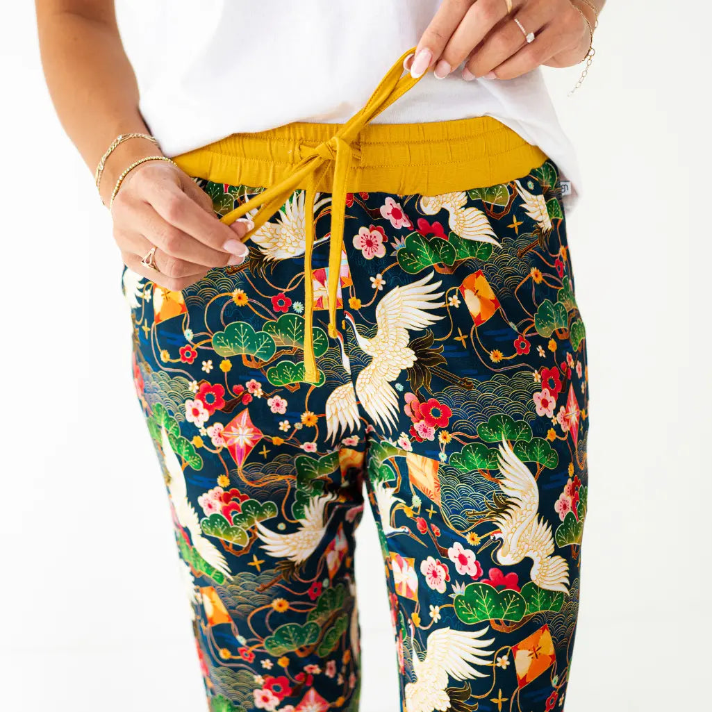 Colorful patterned pants with a yellow drawstring on a white background