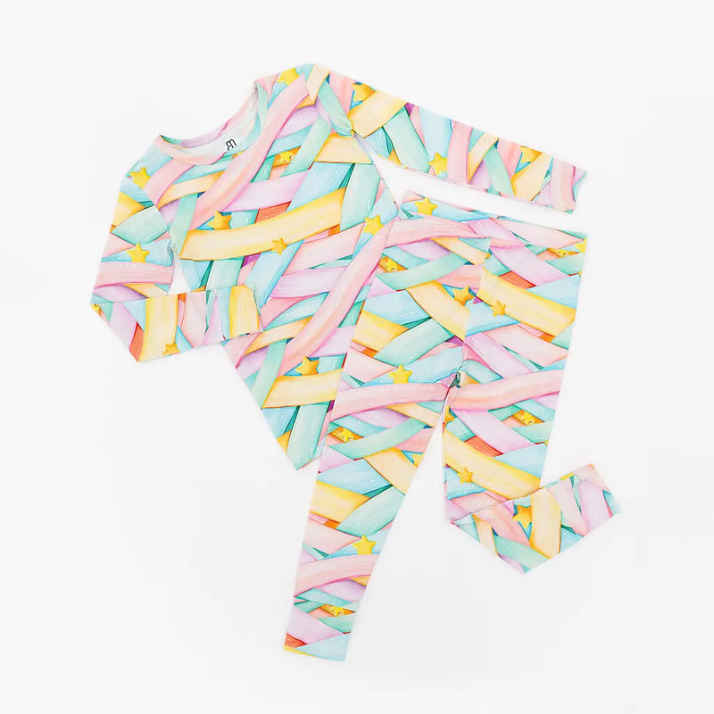 Colorful pastel abstract patterned long-sleeve shirt and pants set with stars on a white background