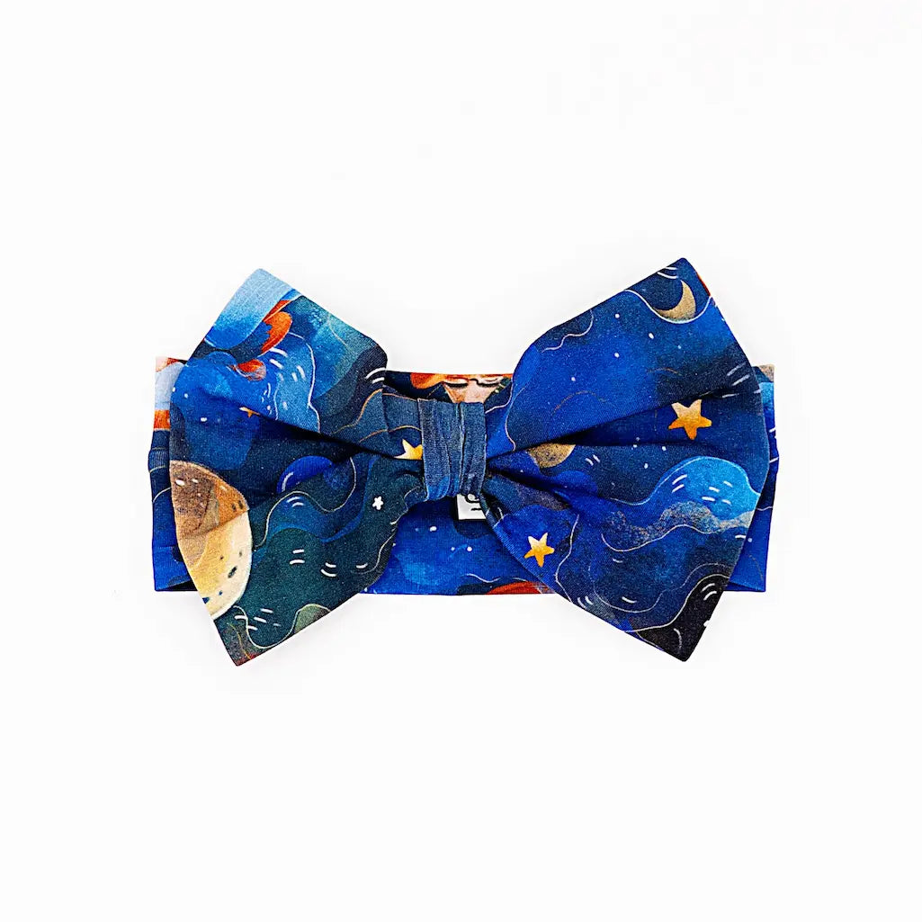 Blue bow tie featuring a space-themed design with stars, moons, and planets on a white background
