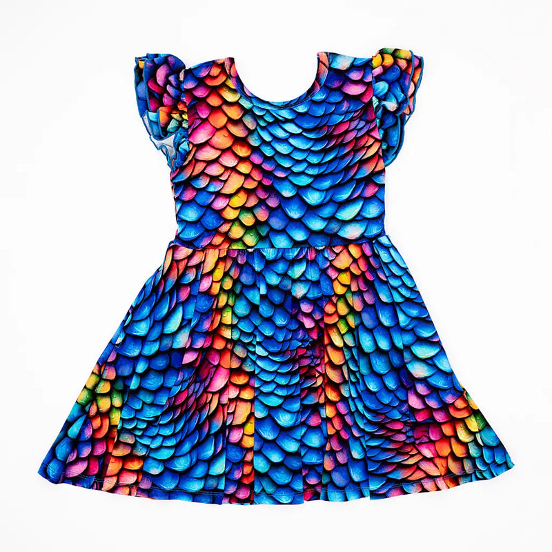 Dress with colorful scale pattern on a white background