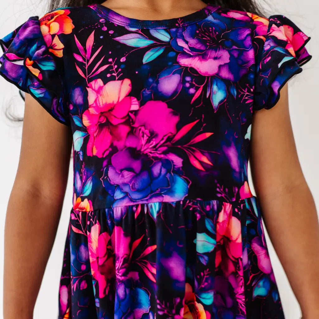 Colorful floral dress with ruffled sleeves on a white background