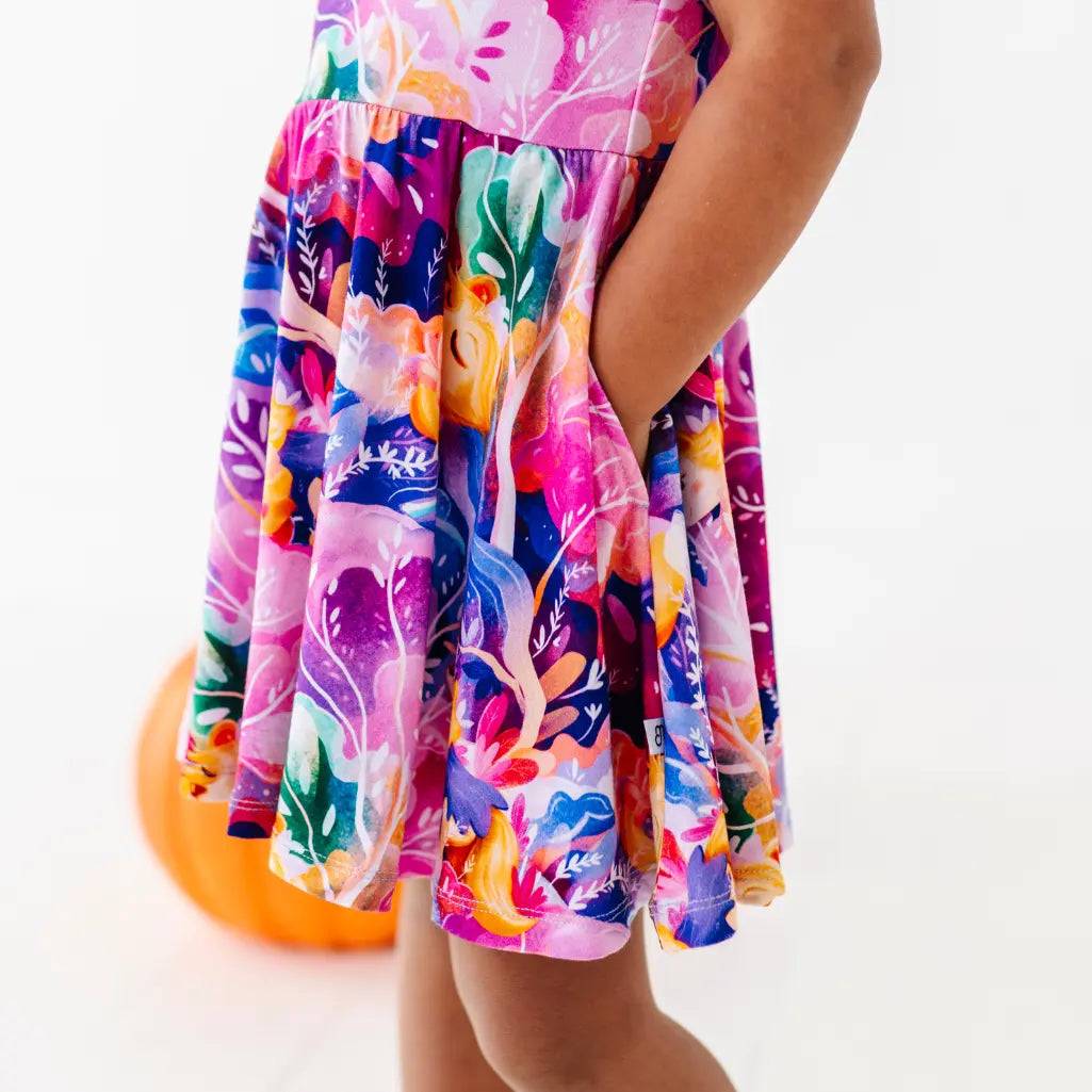 Colorful floral dress worn by a person on a white background