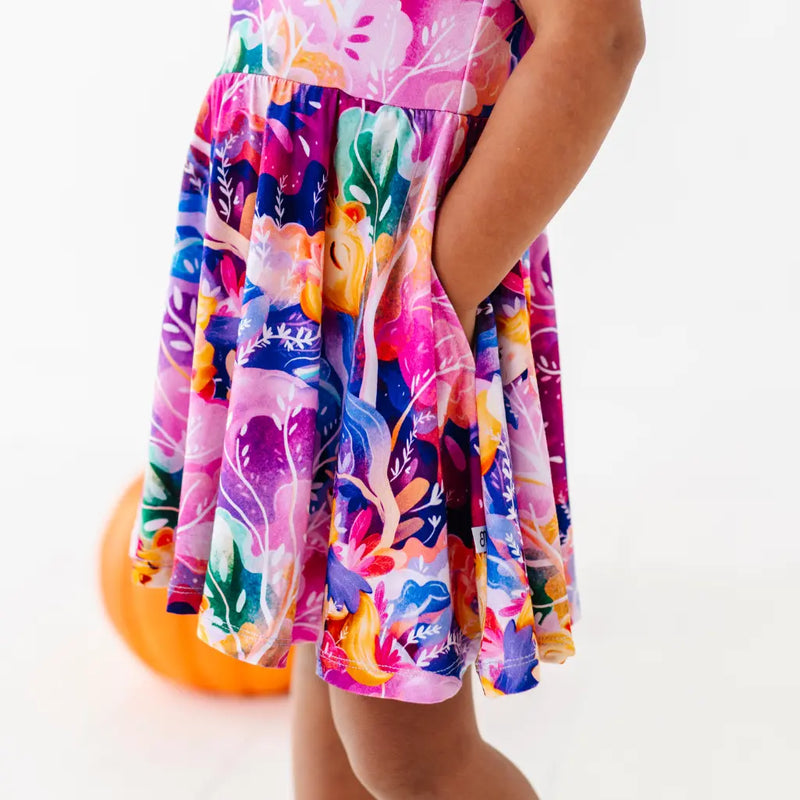 Colorful floral dress worn by a person on a white background