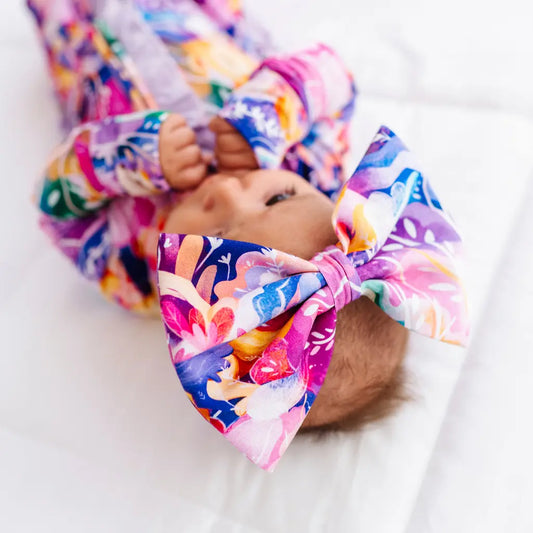 Baby with colorful headband on a white background