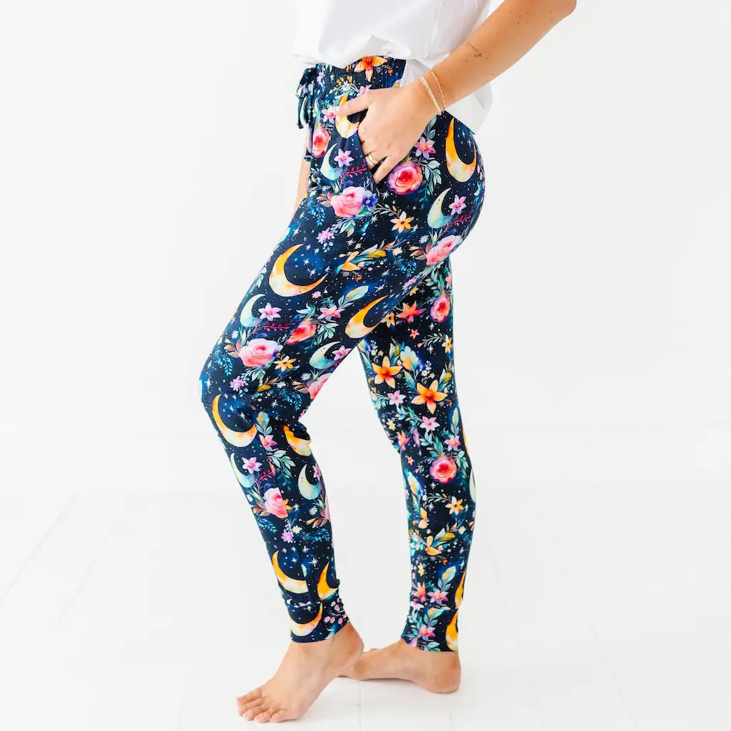 Leggings with floral and moon design worn by a person on a white background