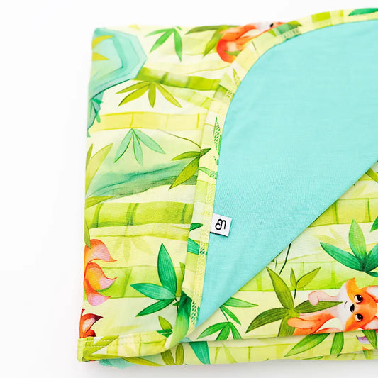 Children's blanket with fox and floral pattern on a white background