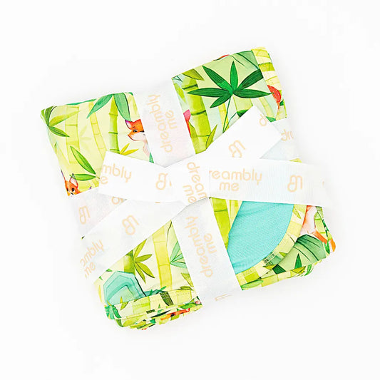 Set of colorful baby bloomers with a tropical leaf pattern on a white background