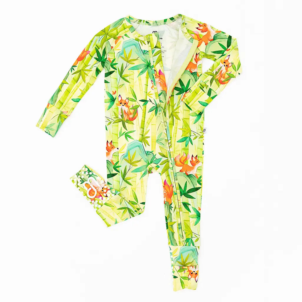 Children's onesie with a colorful animal pattern on a white background