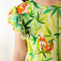 Close-up of a dress with fox and bamboo pattern on a white background