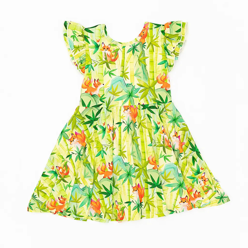 Colorful dress with fox and palm tree pattern on a white background